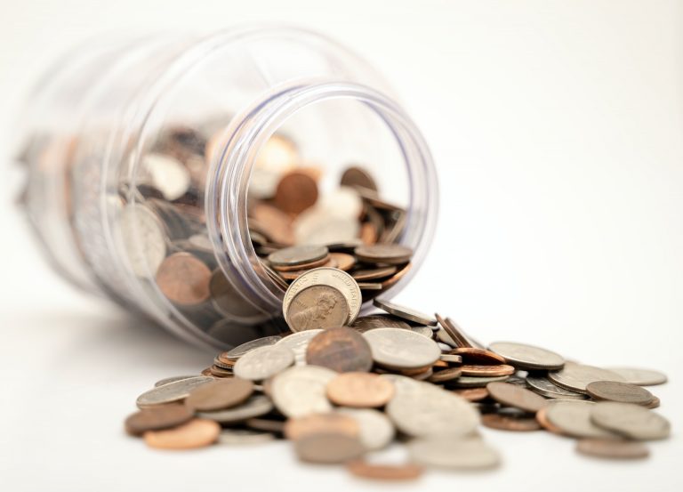 coin spilling out of jar